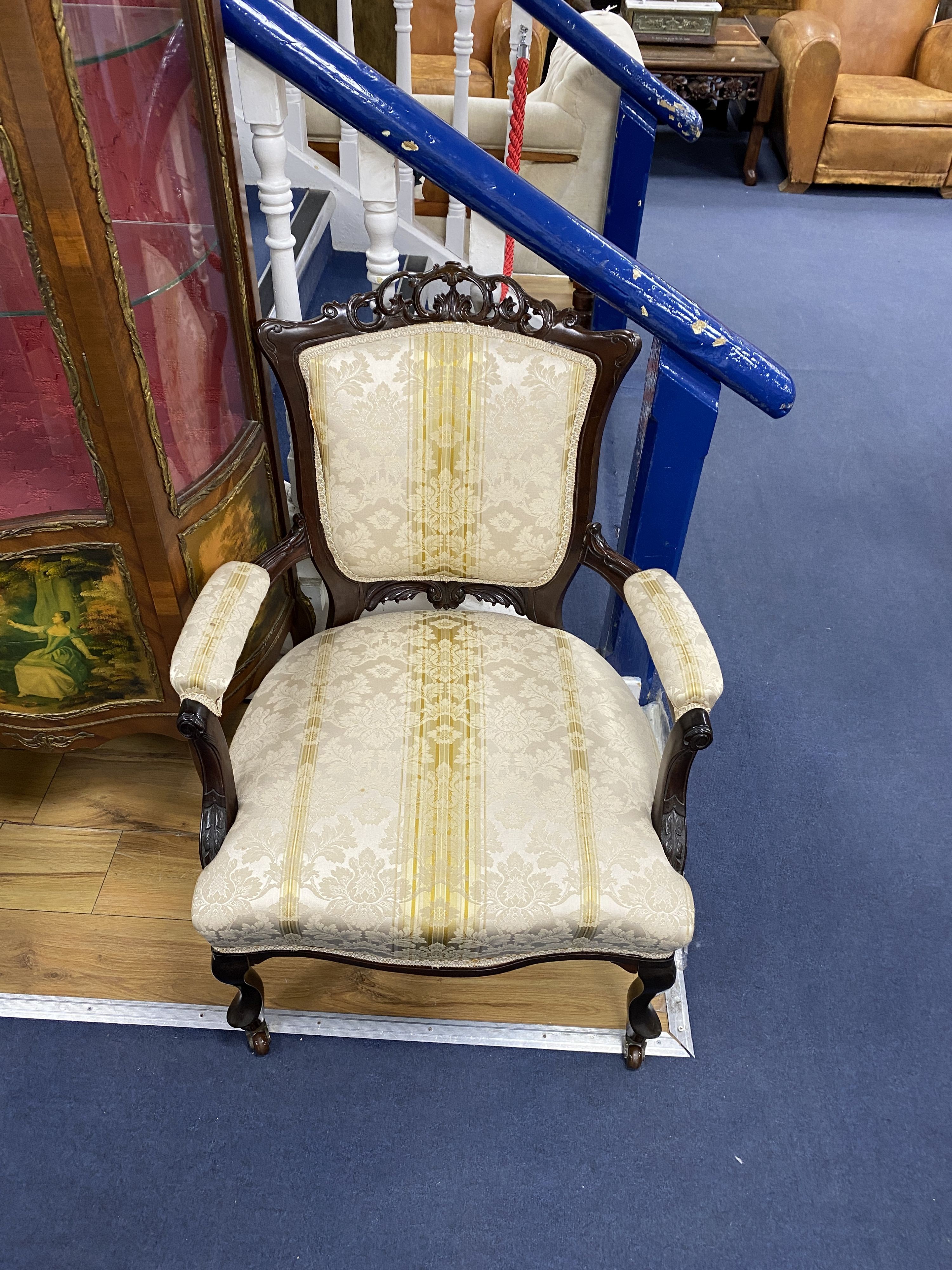 A pair of late Victorian carved mahogany open armchairs, width 66cm, depth 70cm, height 76cm